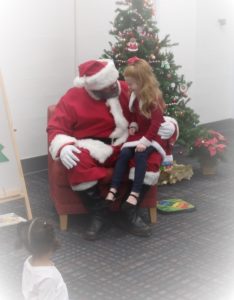 C telling Santa what she wants for Christmas