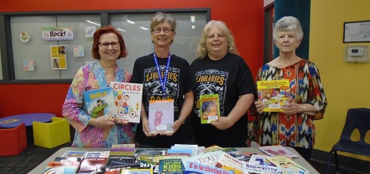 Sedalia Staff and Council members diplaying donated books