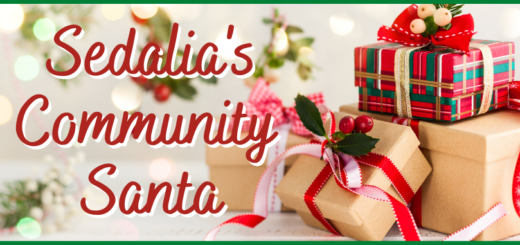 Sedalia's Community Santa with stack of Christmas presents