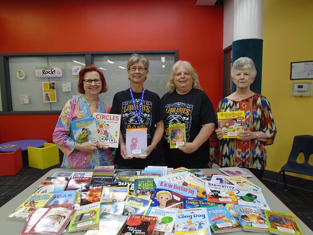 Sedalia Staff and Council members diplaying donated books