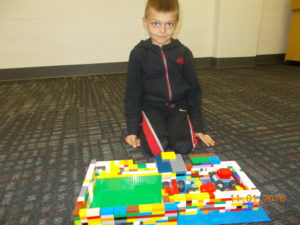 Young boy with Lego structure