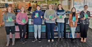 teens with Angela Roquet holding books